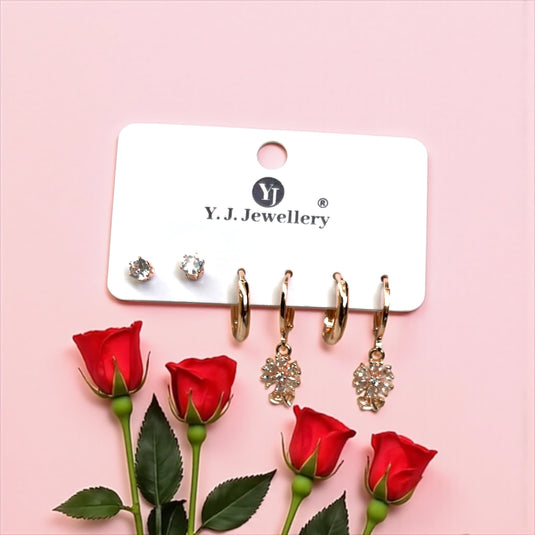 Y.J. Jewellery earrings on a card with red roses on a pink background