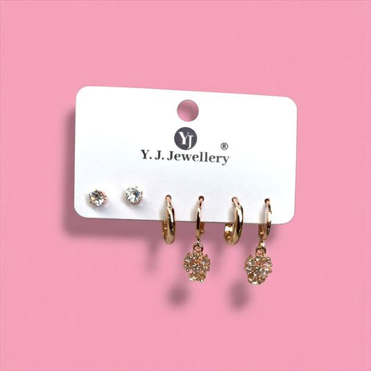 Set of earrings on a Y.J. Jewellery card against a pink background