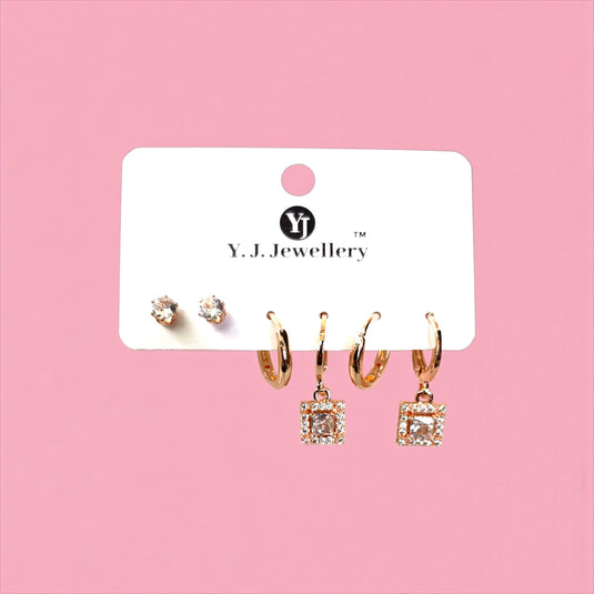 Set of earrings on a Y.J. Jewellery card against a pink background