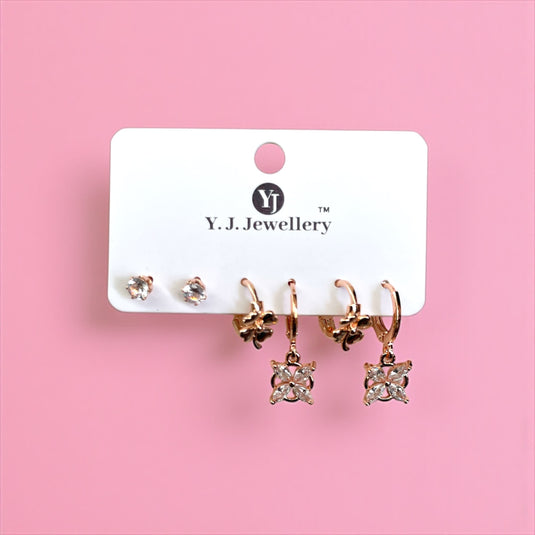 Set of earrings on a Y.J. Jewellery branded card against a pink background